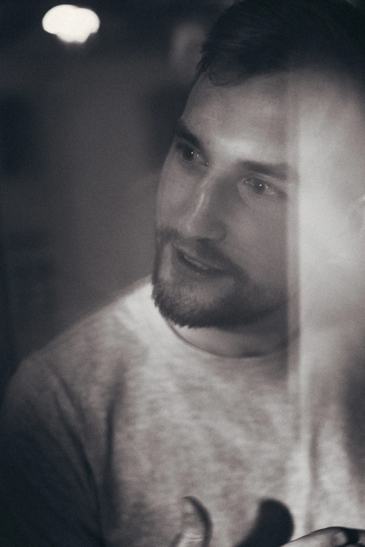 Black-and-white close portrait of a man looking to one side.
